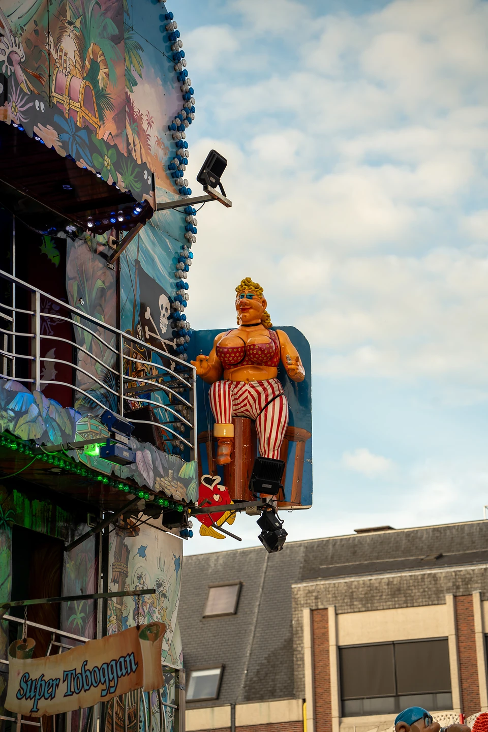 A sculpted pirate figure on a barrel high on the funhouse, a ‘Super Toboggan’ banner below